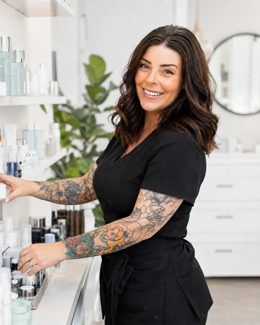 Vegas Sugaring & Wax owner selecting skincare products in the studio