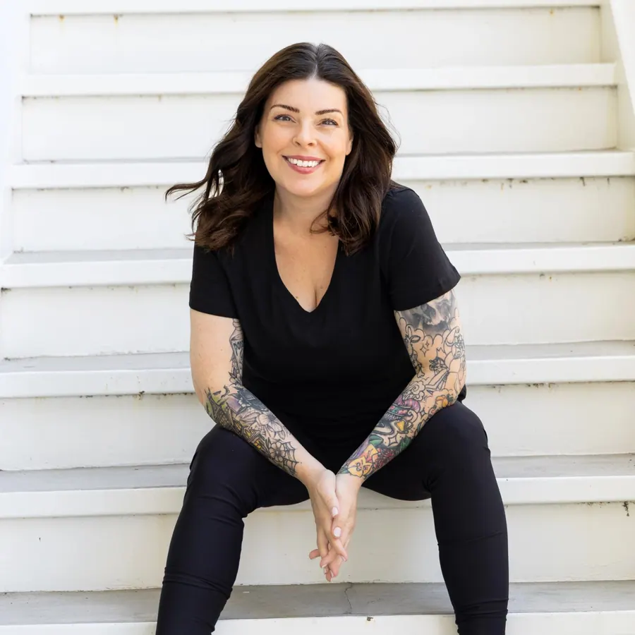 Vegas Sugaring & Wax owner seated on steps, smiling